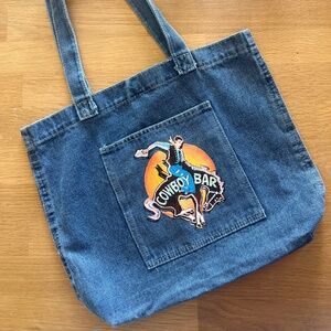 Hand painted Jackson Hole Million Dollar Cowboy Bar western denim bag